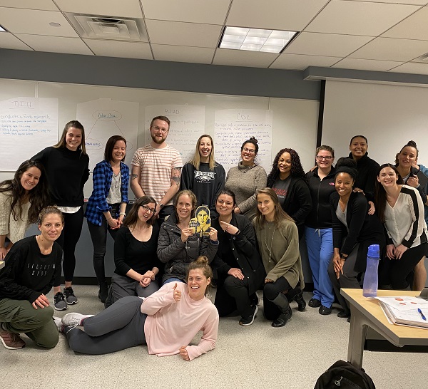 Students in the Nursing Population Health Concepts course posing as a group with FlatFlo